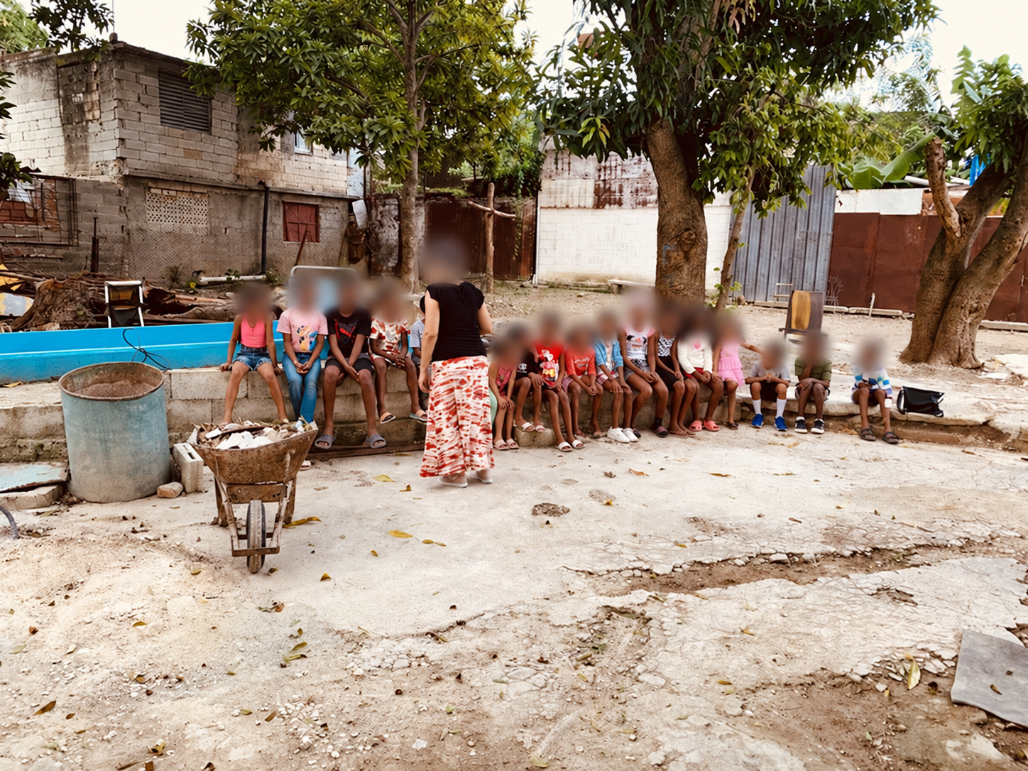 An outdoor community activity, with faces blurred for privacy